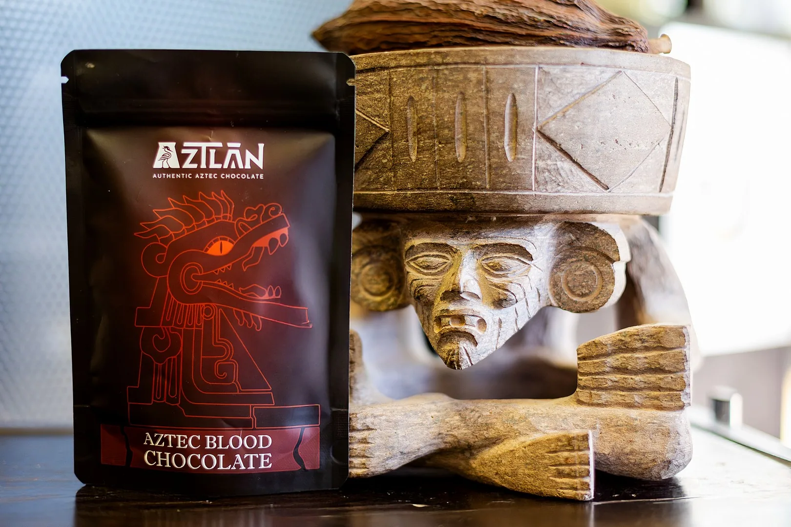 AztecBlood pouch standing beside an Aztec stone idol